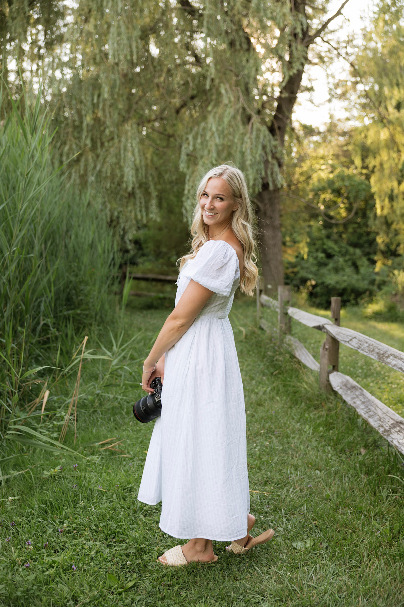 Abby Jones standing holding her camera